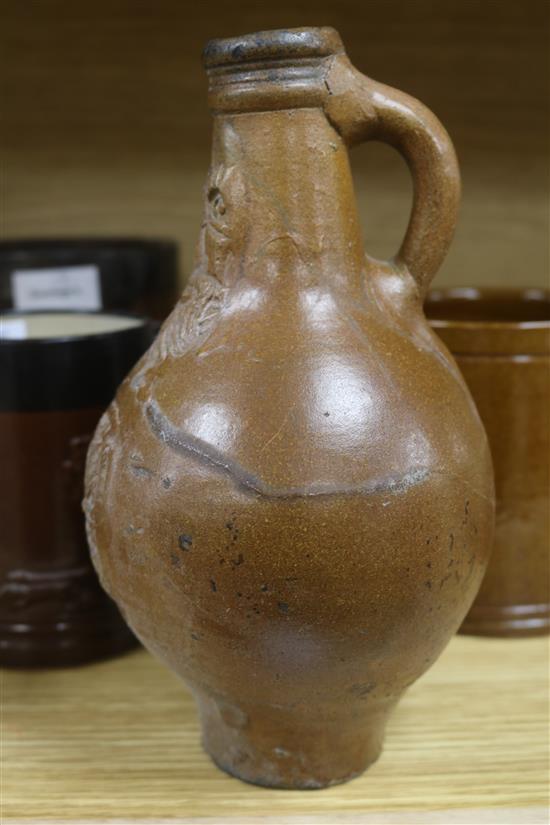 A staved oak grain measure, six various earthenware jugs, mugs, a vase and a 17th century saltglazed Bellarmine (restored) (8)